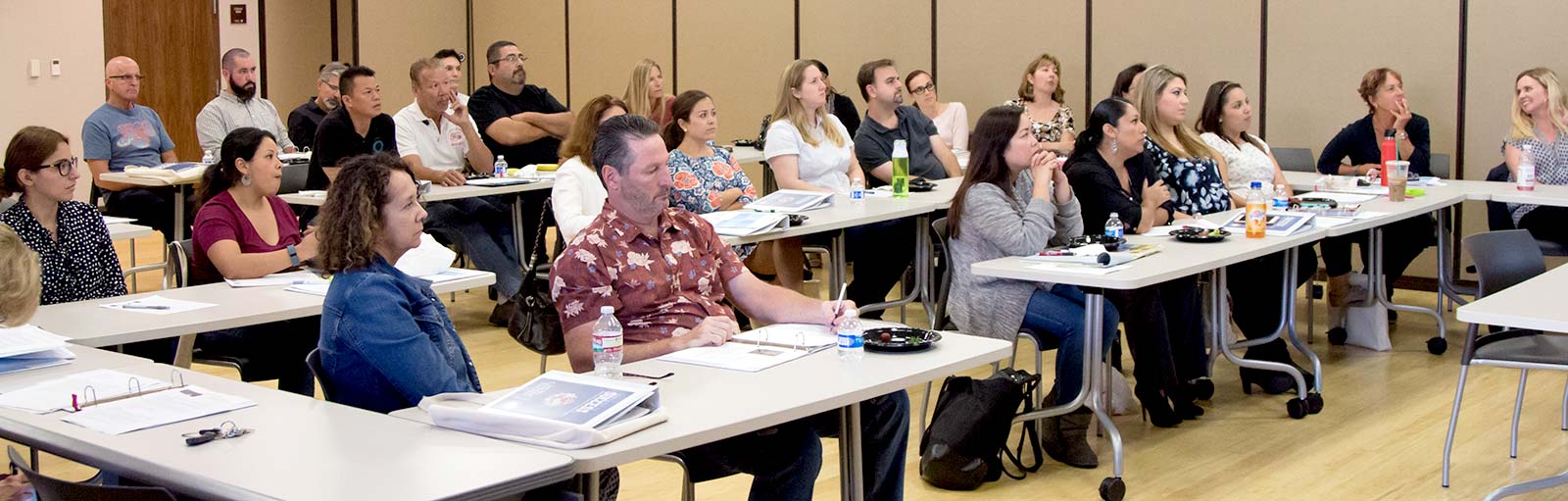 SDCCE faculty sitting at tables in the conference room
