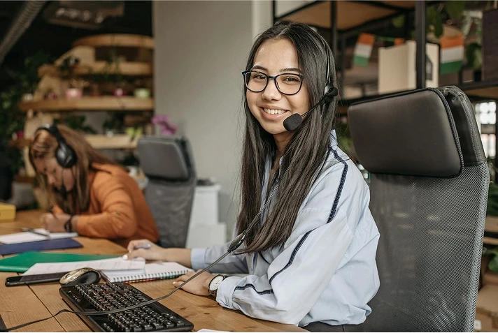 Student smiling at desk