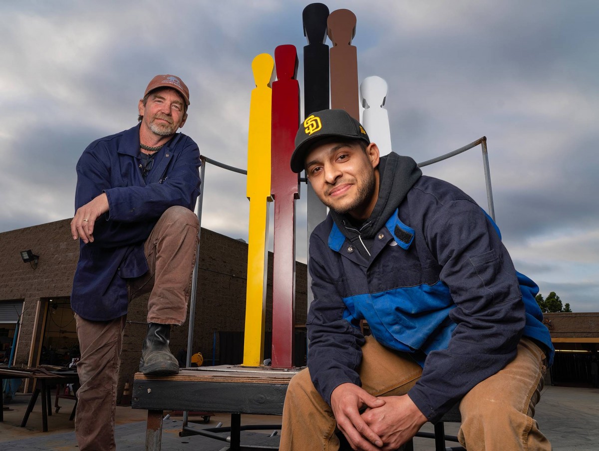 College of Continuing Education student Nathan Torres and welding professor Mike Bradbury with a replica that students created of The Black Family statue at the college’s Educational Cultural Complex. 