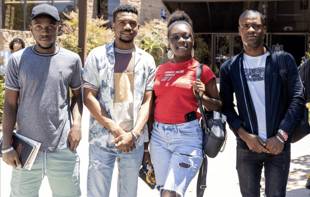 Students pose outside the Educational Cultural Complex